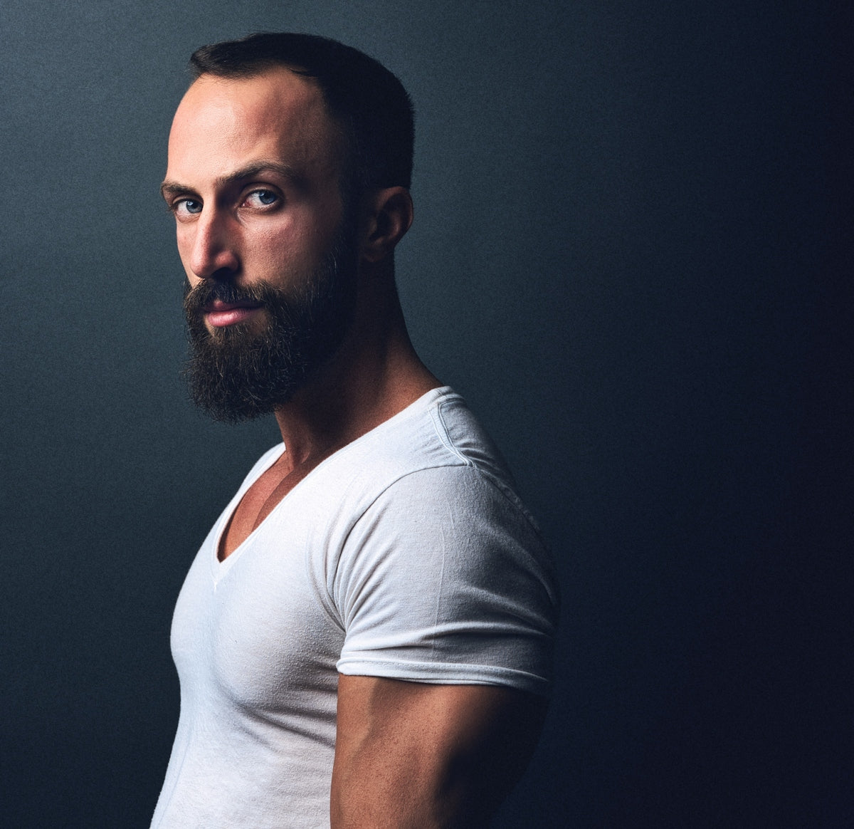 a man with a beard wearing a white shirt