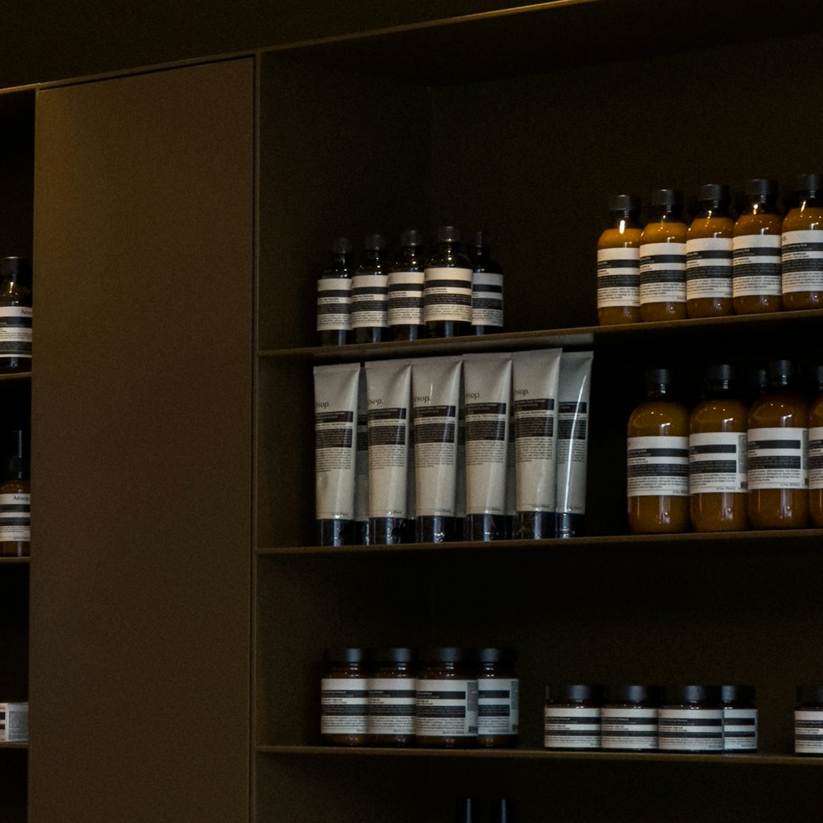 A shelf filled with lots of bottles of liquid